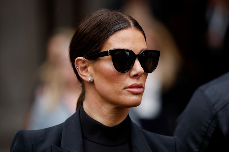 © Reuters. FILE PHOTO: Rebekah Vardy, wife of Leicester City soccer player Jamie Vardy, leaves the Royal Courts of Justice, in London, Britain May 11, 2022. REUTERS/John Sibley