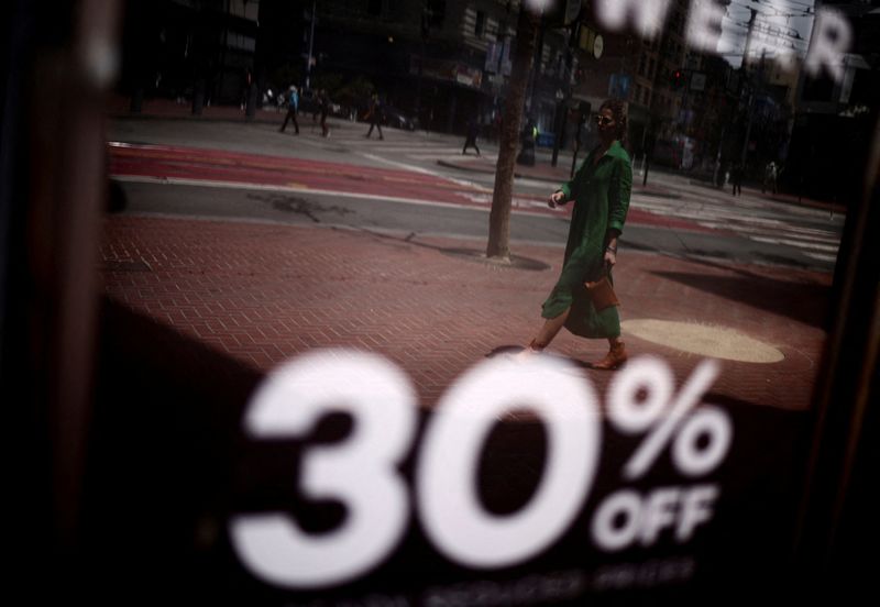 &copy; Reuters. FILE PHOTO: A woman walks by a local shop as discounts are displayed, in downtown San Francisco, California, U.S., July 13, 2022. REUTERS/Carlos Barria