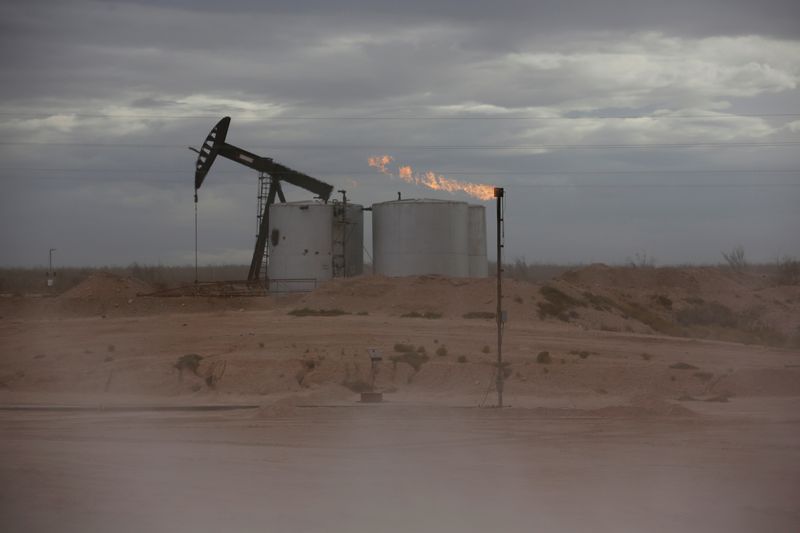 &copy; Reuters. FILE PHOTO: Dust blows around a crude oil pump jack and flare burning excess gas at a drill pad in the Permian Basin in Loving County, Texas, U.S. November 25, 2019. Picture taken November 25, 2019.  REUTERS/Angus Mordant/File Photo/File Photo