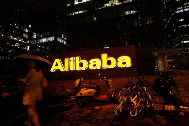 &copy; Reuters. FILE PHOTO: The logo of Alibaba Group is seen lit up at its office building in Beijing, China August 9, 2021. REUTERS/Tingshu Wang