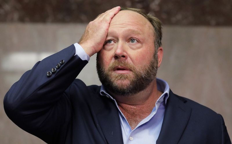 © Reuters. FILE PHOTO: Alex Jones of Infowars talks to the media while visiting the U.S. Senate's Dirksen Senate office building as Twitter CEO Jack Dorsey testifies before a Senate Intelligence Committee hearing on Capitol Hill in Washington, U.S., September 5, 2018. Twitter permanently banned Jones and Infowars from its platforms September 6 over his actions seen on Twitter while visiting the building. REUTERS/Jim Bourg