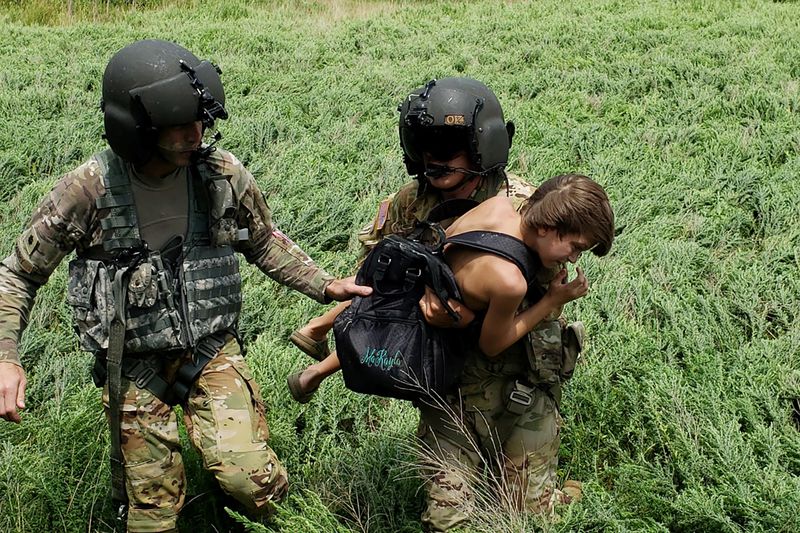 &copy; Reuters. Kentucky National Guard helicopter crew members carry a victim of flooding, during their deployment in response to a declared state of emergency in eastern Kentucky, U.S. July 27, 2022. U.S. Army National Guard/Handout via REUTERS 