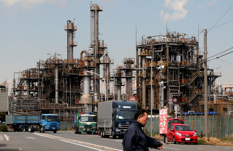 &copy; Reuters. FILE PHOTO - A worker walks near a factory at the Keihin industrial zone in Kawasaki, Japan, March 8, 2017. REUTERS/Toru Hanai