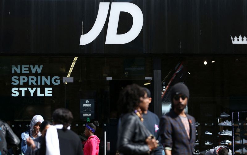 &copy; Reuters. FILE PHOTO: People pass by a JD Sports store in London, Britain April 11, 2017. REUTERS/Neil Hall/File Photo