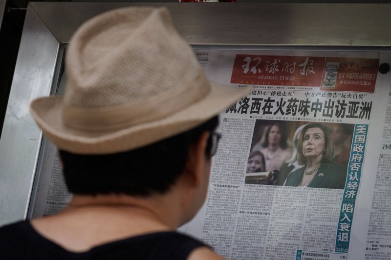 &copy; Reuters. Un hombre lee el periódico Global Times con un artículo en primera página sobre la gira por Asia de la presidenta de la Cámara de Representantes de EEUU, Nancy Pelosi, en un muro de exposición en Pekín, China, 1 de agosto de 2022. REUTERS/Thomas Pet