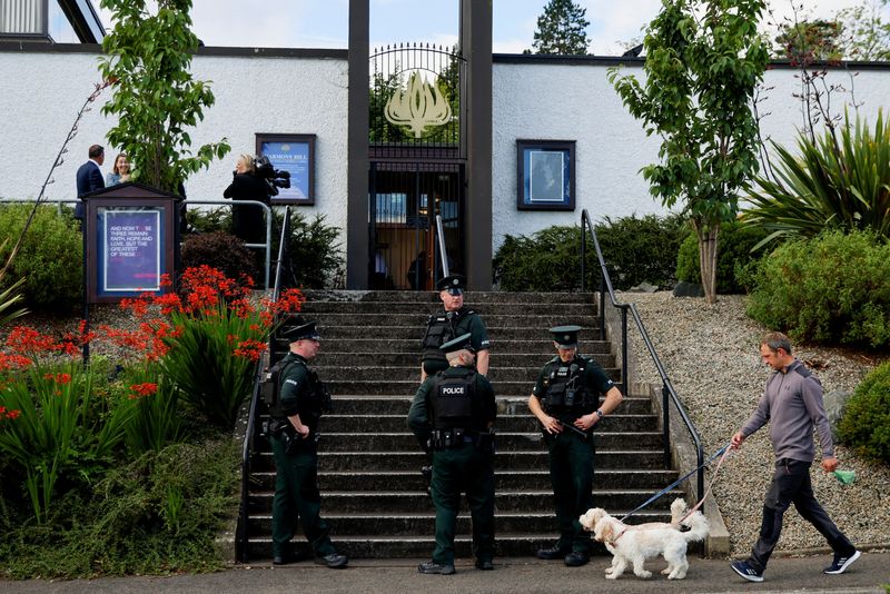 &copy; Reuters. Police officers stand guard outside Harmony Hill Presbyterian Church, the location of the funeral of Northern Ireland's former First Minister David Trimble, one of the key peace brokers of the Good Friday Agreement, in Lisburn, Northern Ireland, August 1,