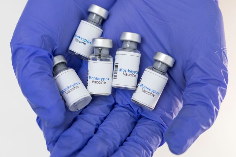 © Reuters. FILE PHOTO: A woman holds mock-up vials labeled 