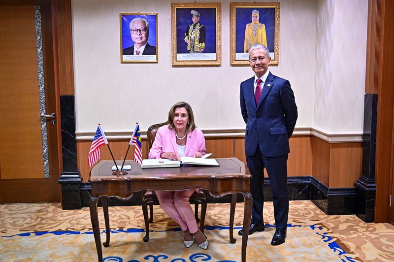 &copy; Reuters. U.S. House of Representatives Speaker Nancy Pelosi sits while signing the guest book as Malaysia's Parliament Speaker Azhar Azizan Harun stands next to her, during their meeting at Malaysian Houses of Parliament in Kuala Lumpur, Malaysia, August 2, 2022. 