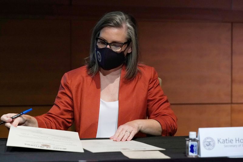 &copy; Reuters. FILE PHOTO: Arizona Secretary of State Katie Hobbs looks over the Arizona Presidential Electoral Ballot from the members of Arizona's Electoral College in Phoenix, Arizona, U.S. December 14, 2020. Ross D. Franklin/Pool via REUTERS