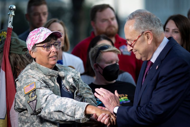 © Reuters. Senate Majority Leader Chuck Schumer (D-NY) embraces a veteran during a news confrence, following the completion of a vote on the Promise to Address Comprehensive Toxics (PACT) Act on Capitol Hill in Washington, U.S., August 2, 2022. REUTERS/Tom Brenner