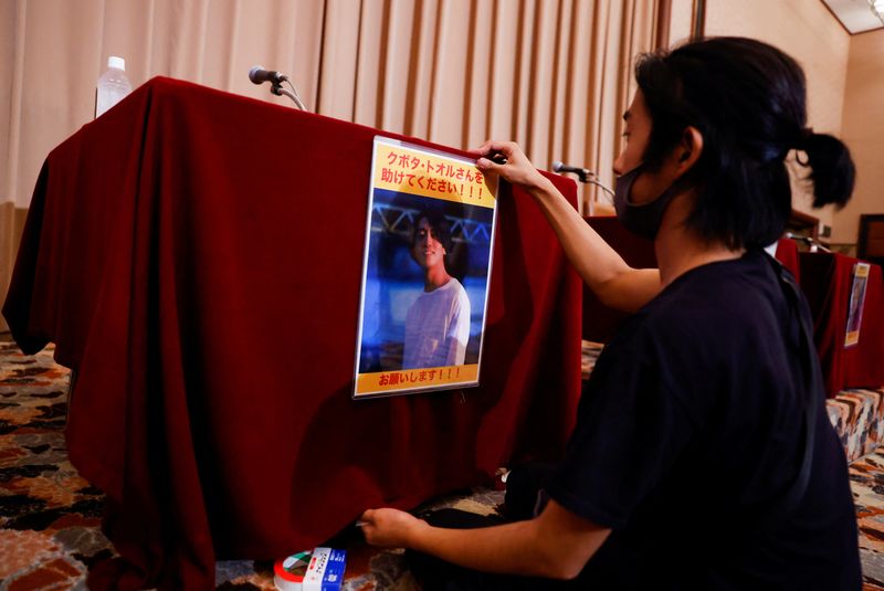 &copy; Reuters. 　８月４日、ミャンマー最大都市ヤンゴンで当局に拘束された日本人ジャーナリスト、久保田徹氏が訴追されたと、ＢＢＣビルマが伝えた。写真は同氏が載ったポスターを張る男性。都内で