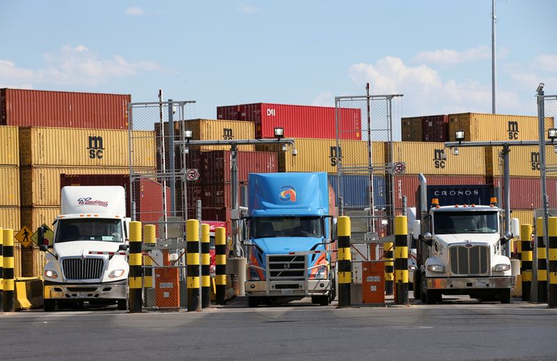 &copy; Reuters. FILE PHOTO: Trucks loaded with shipping containers leave the Port of Montreal in Montreal, Quebec, Canada, May 17, 2021.  REUTERS/Christinne Muschi/File Photo