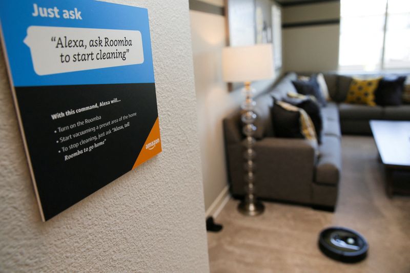 © Reuters. FILE PHOTO: Prompts on how to use Amazon's Alexa personal assistant are seen as a wifi-equipped Roomba begins cleaning a room in an Amazon ‘experience center’  in Vallejo, California, U.S., May 8, 2018. REUTERS/Elijah Nouvelage/File Photo