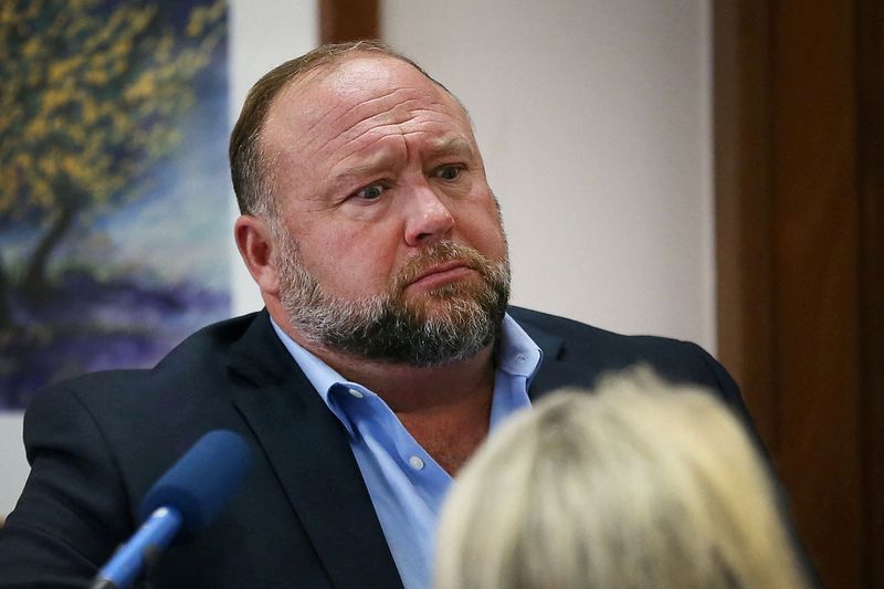 &copy; Reuters. Alex Jones attempts to answer questions about his emails asked by Mark Bankston, lawyer for Neil Heslin and Scarlett Lewis, during trial at the Travis County Courthouse, Austin, Texas, U.S., August 3, 2022.  Briana Sanchez/Pool via REUTERS    