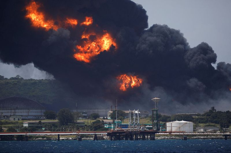&copy; Reuters. FILE PHOTO: Fire is seen over fuel storage tanks that exploded near Cuba's supertanker port in Matanzas, Cuba, August 6, 2022. REUTERS/Alexandre Meneghini/File Photo