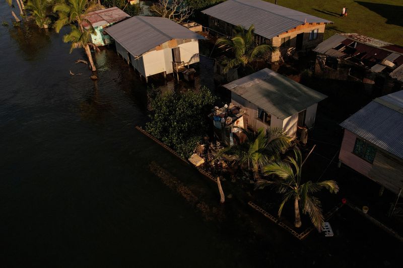 &copy; Reuters. FILE PHOTO: Seawater floods past an ineffective sea wall into the community of Veivatuloa Village, Fiji, July 16, 2022. Leaders of 15 low-lying Pacific island nations declared climate change their "single greatest existential threat" at a mid-July summit 