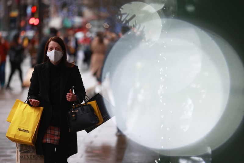&copy; Reuters. FILE PHOTO: A shopper walks on Oxford Street in London, Britain December 18, 2020. REUTERS/Hannah Mckay