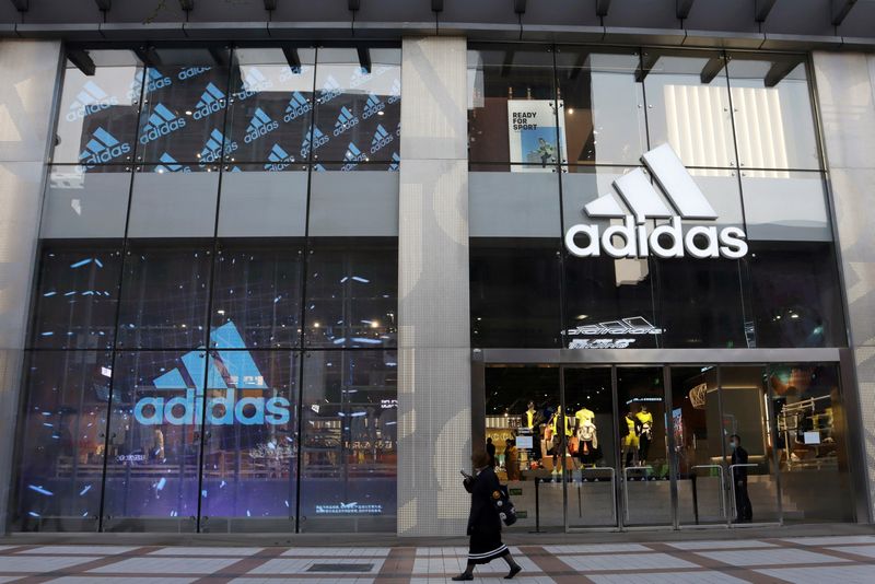 &copy; Reuters. FILE PHOTO: A woman walks past a store of sporting goods retailer Adidas at a shopping mall in Beijing, China March 25, 2021. REUTERS/Florence Lo/File Photo