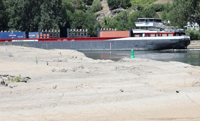 &copy; Reuters. FILE PHOTO: A container vessel passes the Loreley Rock at low water levels as recent dry weather continues, that prevented cargo vessels from sailing fully loaded on the river Rhine, in Sankt Goar, Germany, July 19, 2022. REUTERS/Wolfgang Rattay