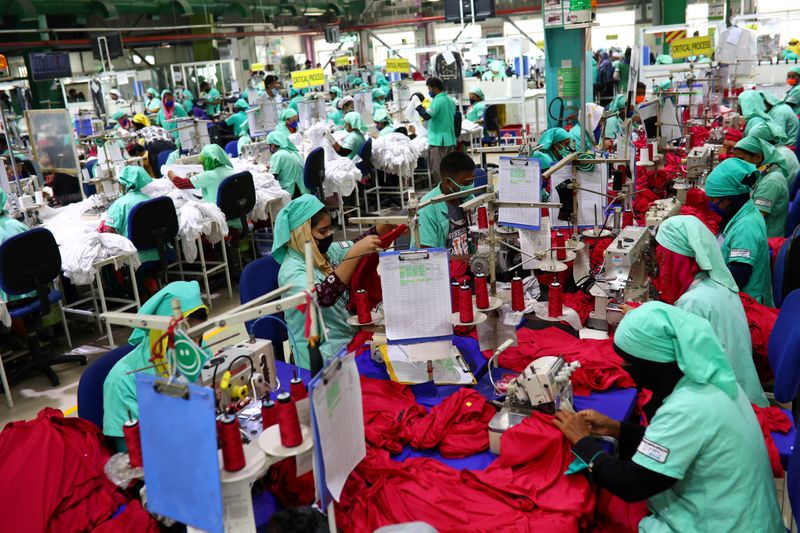 &copy; Reuters. FILE PHOTO: Garment employees work in a sewing section of the Fakhruddin Textile Mills Limited in Gazipur, Bangladesh, February 7, 2021.  REUTERS/Mohammad Ponir Hossain/File Photo