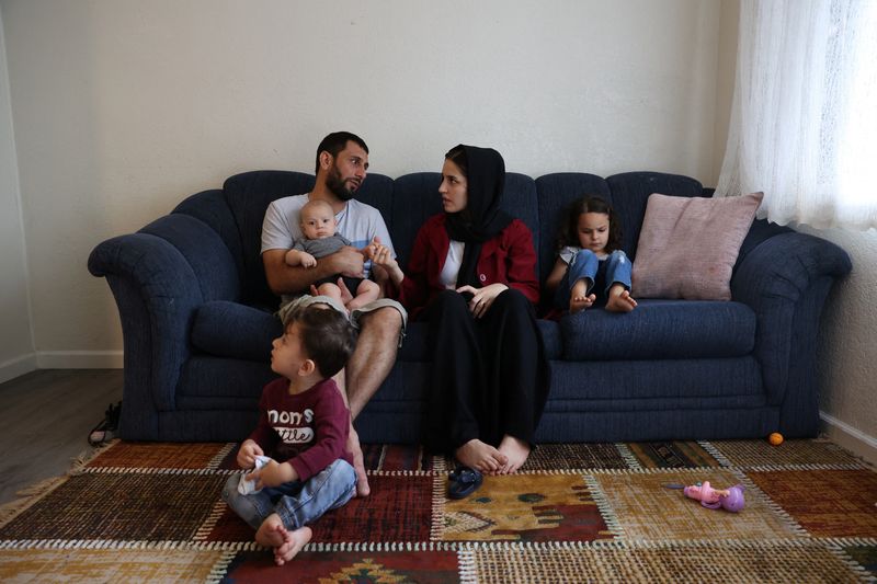 &copy; Reuters. The Mohammadi family, Najib holding Yusuf, Yasar, Susan and Zahra, sit together in their living room, at their home in Sacramento, California, U.S., August 1, 2022. Najib Mohammadi had high hopes for his life in the United States when he, his pregnant wif