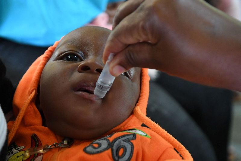 © Reuters. A baby receives the Rotavirus vaccination at Fort Portal Regional Referral Hospital in Uganda, November 2021. UNICEF/Wamala/Handout via REUTERS  