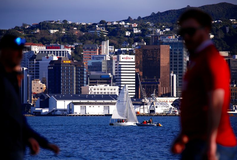 &copy; Reuters. FILE PHOTO: Pedestrians walk past a sailing boat as it passes in front of the central business district (CBD) of Wellington in New Zealand, July 2, 2017. REUTERS/David Gray
