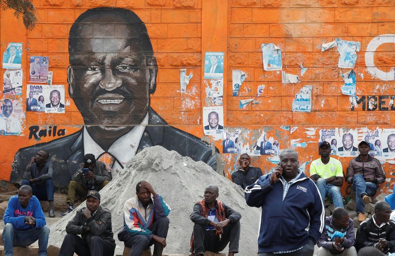 &copy; Reuters. People sit next to a wall mural of Raila Odinga the presidential candidate for Azimio la Umoja and One Kenya Alliance, after the general election conducted by the Independent Electoral and Boundaries Commission (IEBC) in Kibera slums of Nairobi, Kenya Aug