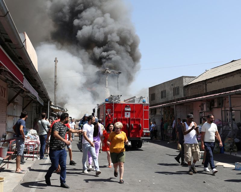 © Reuters. دخان يتصاعد في سماء يريفان بعد انفجار في مستودع للألعاب النارية يوم الأحد. صورة من وكالة فوتولور حصلت عليها رويترز من طرف ثالث. 