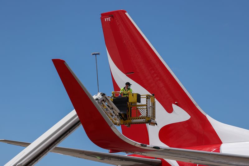 &copy; Reuters. FILE PHOTO: An aircraft appearance crew member cleans an aircraft as Qantas begins preparing and equipping planes for the return of international flights, in anticipation of Australia easing coronavirus disease (COVID-19) border regulations, at Sydney Air