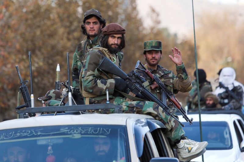 &copy; Reuters. FILE PHOTO: Members of Taliban sit on a military vehicle during Taliban military parade in Kabul, Afghanistan November 14, 2021. REUTERS/Ali Khara