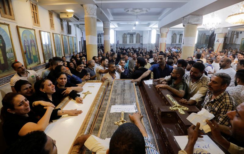 © Reuters. People react during the funeral of victims, who died due to the fire that broke out at the Abu Sifin church, inside the Church of the Blessed Virgin Mary at Warraq Al Arab district in Giza Governorate, Egypt, August 14, 2022. REUTERS/Mohamed Abd El Ghany