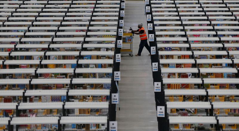 &copy; Reuters. FILE PHOTO: A worker collects orders at Amazon's fulfilment centre in Rugeley, central England December 11, 2012.  REUTERS/Phil Noble
