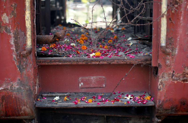 &copy; Reuters. FILE PHOTO: Flower petals scattered by the relatives of Godhra riots victims are pictured at the doorsteps of a train carriage, that was set on fire in 2002, during the commemoration of the 12th anniversary of Godhra riots at Godhra in the western Indian 