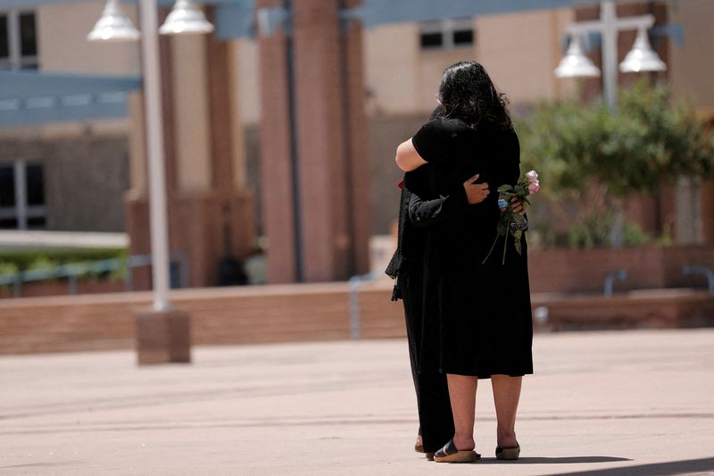 &copy; Reuters. FILE PHOTO: Two people embrace during a unity event against anti-Shia hate following the murders of four Muslim men in Albuquerque, New Mexico, U.S., August 12, 2022.  REUTERS/Adria Malcolm/File Photo
