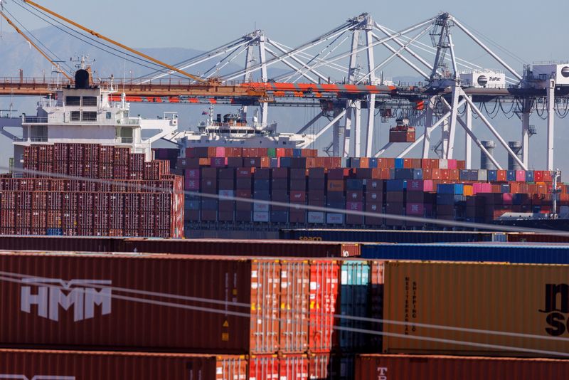 &copy; Reuters. FILE PHOTO: Stacked containers are shown as ships unload their cargo at the Port of Los Angeles in Los Angeles, California, U.S. November 22, 2021. REUTERS/Mike Blake