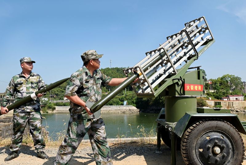 &copy; Reuters. FOTO DE ARCHIVO. Miembros de la milicia cargan un equipo para operaciones de siembra de nubes como parte de las medidas de alivio de la sequía en medio de una advertencia de ola de calor en el condado de Dongkou de Shaoyang, provincia de Hunan, China. 17