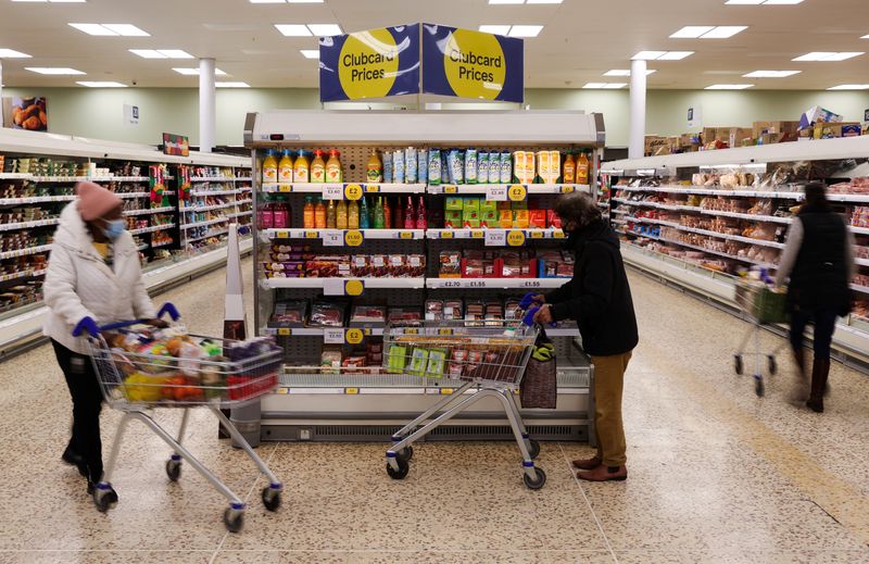 &copy; Reuters. Clubcard branding is seen next to shoppers inside a branch of a Tesco Extra Supermarket in London, Britain, February 10, 2022. Picture taken February 10, 2022. REUTERS/Paul Childs