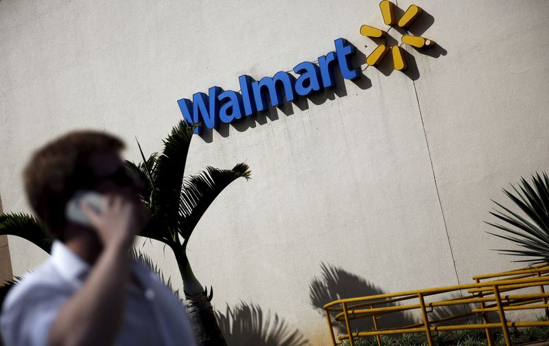 &copy; Reuters. FILE PHOTO: A man talks on his mobile phone in front of a Walmart store in Sao Paulo, Brazil, February 16, 2016. REUTERS/Nacho Doce/File Photo