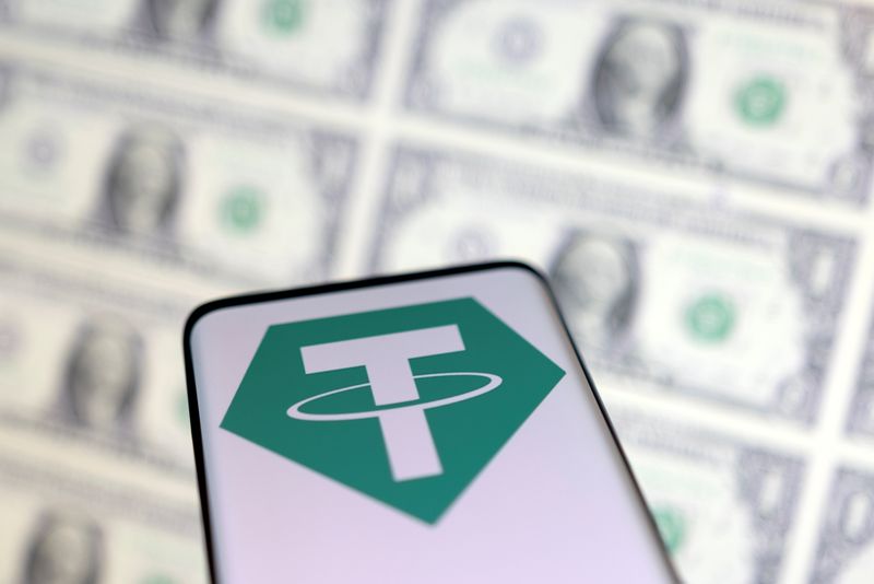 &copy; Reuters. FILE PHOTO: Smartphone with Tether logo is placed on displayed U.S. dollars in this illustration taken, May 12, 2022. REUTERS/Dado Ruvic/Illustration