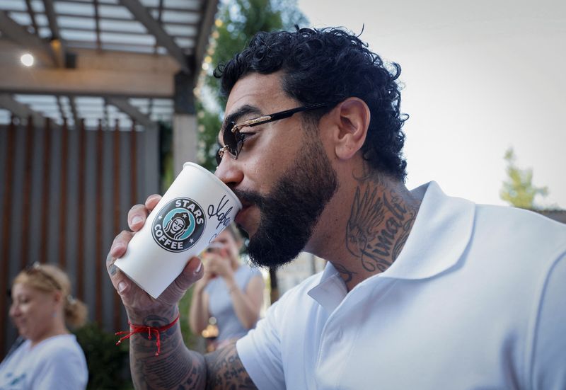 &copy; Reuters. Rapper Timati, co-owner of the new coffee shop "Stars Coffee", which opens following Starbucks Corp company's exit from the Russian market, drinks a coffee, in Moscow, Russia August 18, 2022.  REUTERS/Maxim Shemetov