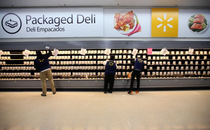 &copy; Reuters. Employees sort shelving for food products as they prepare for the opening of a Walmart Super Center in  Compton, California, U.S., January 10, 2017.  REUTERS/Mike Blake/File Photo