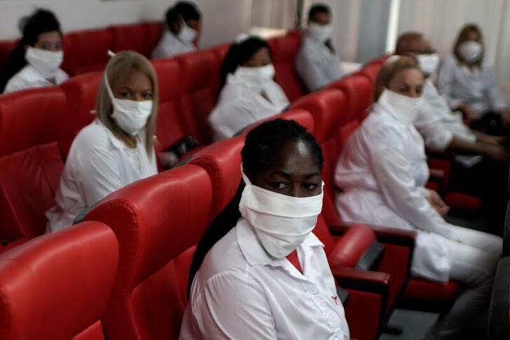 &copy; Reuters. Cuban doctors sit prior to a farewell ceremony before departing to Kuwait to assist, amid the coronavirus disease (COVID-19) outbreak, in Havana, Cuba June 4, 2020. REUTERS/Alexandre Meneghini
