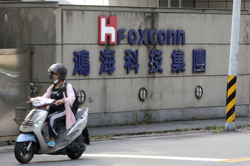 &copy; Reuters. FILE PHOTO: A motorist passes by a Foxconn office building in Taipei, Taiwan, July 14, 2020. REUTERS/Ann Wang/File Photo