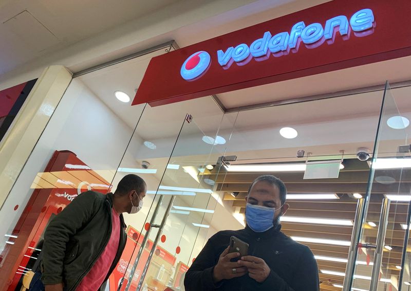 &copy; Reuters. FILE PHOTO: Shoppers wear protective face masks in front of a Vodafone store inside a City Centre mall ahead of Black Friday, amid the coronavirus disease (COVID-19) pandemic in the Cairo suburb of Maadi, Egypt November 26, 2020. REUTERS/Amr Abdallah Dals