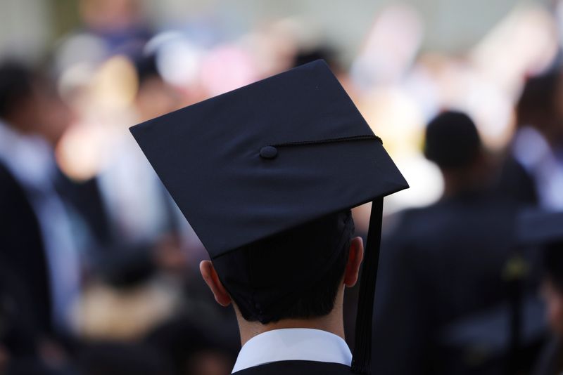 &copy; Reuters. FILE PHOTO - A graduating student waits for the start of the Commencement ceremony at the Massachusetts Institute of Technology (MIT) in Cambridge, Massachusetts, U.S., May 27, 2022.   REUTERS/Brian Snyder