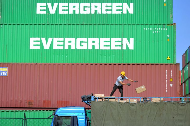 &copy; Reuters. A worker sorts imported goods on a truck next to containers at a port in Qingdao, Shandong province, China October 14, 2019.  REUTERS/Stringer/File Photo