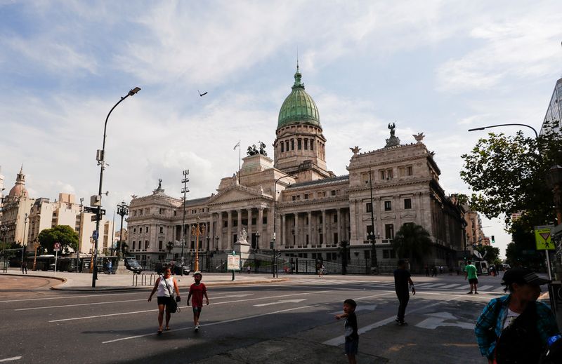 &copy; Reuters. FILE PHOTO: People walk outside the National Congress, as the senate debates the government's agreement with the International Monetary Fund (IMF) in Buenos Aires, Argentina March 17, 2022. REUTERS/Agustin Marcarian