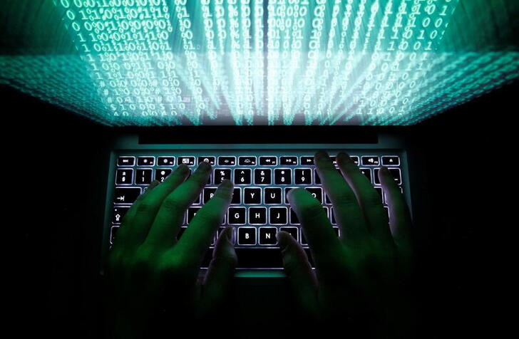 © Reuters. FILE PHOTO: A man types on a computer keyboard in Warsaw in this February 28, 2013 illustration picture. REUTERS/Kacper Pempel/File Photo
