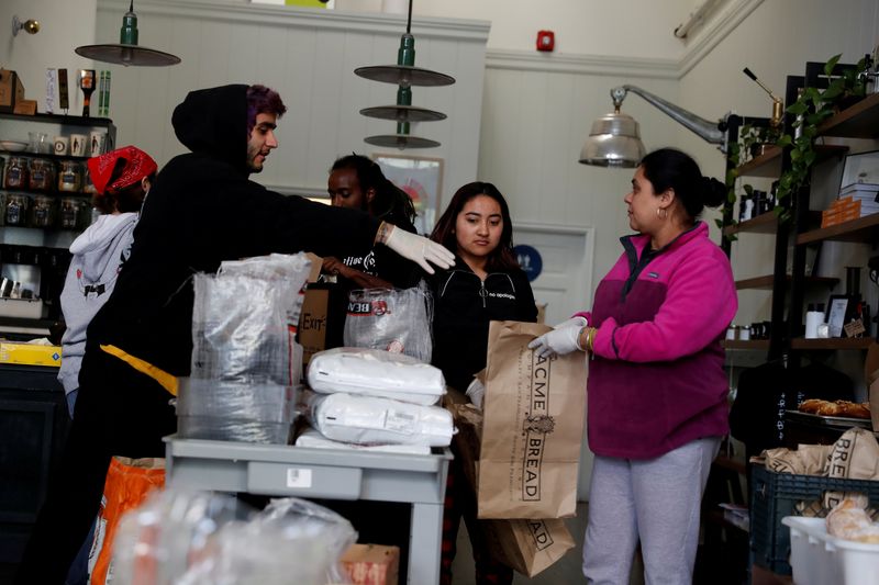 &copy; Reuters. FILE PHOTO: Employees laid off from Farley’s East cafe, that closed due to the financial crisis caused by the coronavirus disease (COVID-19), collect food items at the cafe in Oakland, California, U.S. March 18, 2020. Picture taken March 18, 2020. REUTE